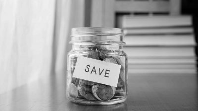 A jar full of coins with a label "Save" illustrating that teams may not always need more money and resources