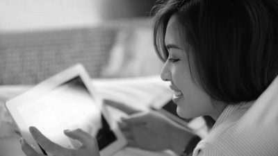 A woman navigating online on her tablet